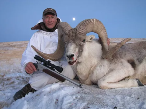 Hunter with handgun and Burris scope with argali sheep 