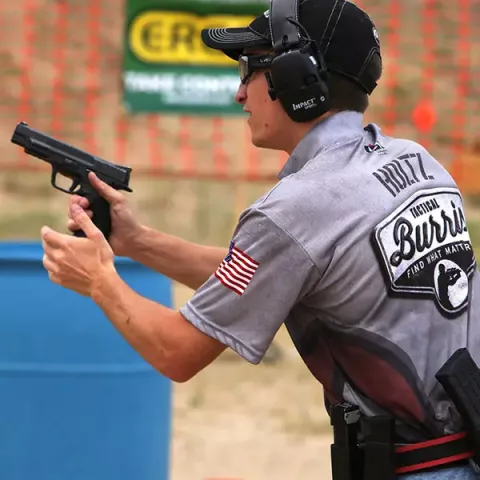 man shooting pistol wearing ear protection