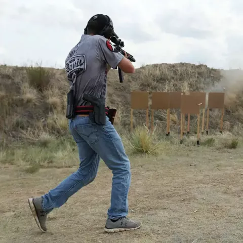 man moving, shooting at targets