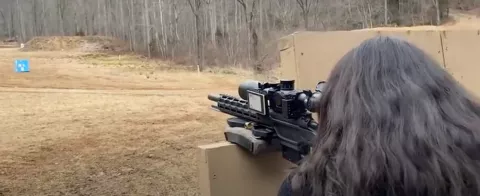 Over the shoulder of a shooter doing long-range shooting