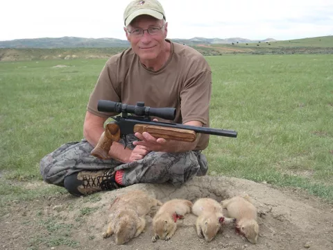Hunter with handgun and Burris scope with prairie dog
