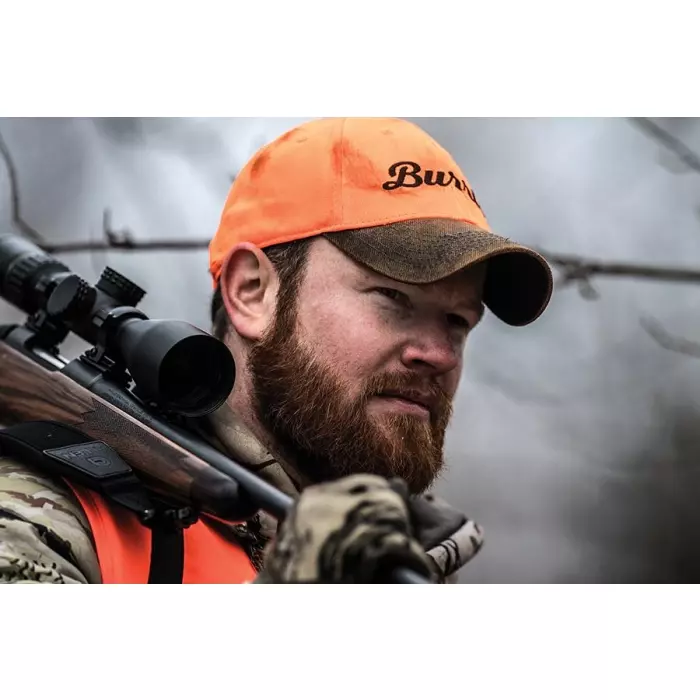 man wearing blaze orange hunting hat